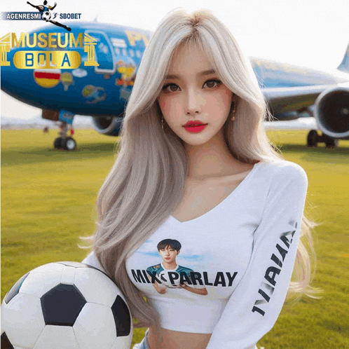 a woman holding a soccer ball in front of an airplane that says museum bola on it