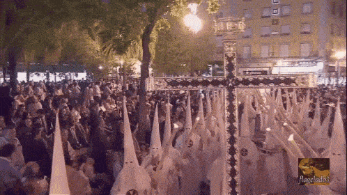 a crowd of people are gathered in front of a large cross and a sign that says ' alianzas ' on it