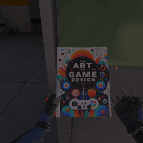 a book titled the art of game design is being held by a person