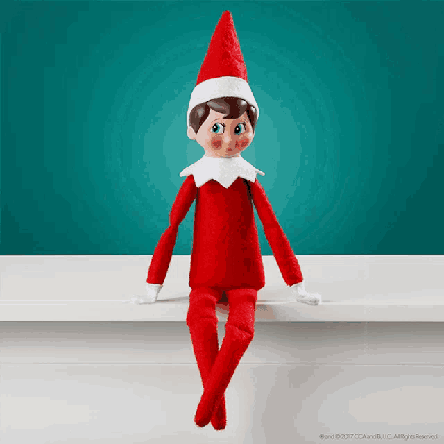 an elf on the shelf is sitting on a shelf with a blue background