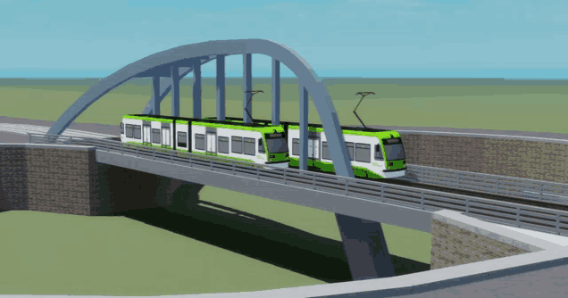 a green and white train is crossing a bridge with a blue sky behind it