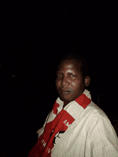 a man wearing a red and white scarf that says amv