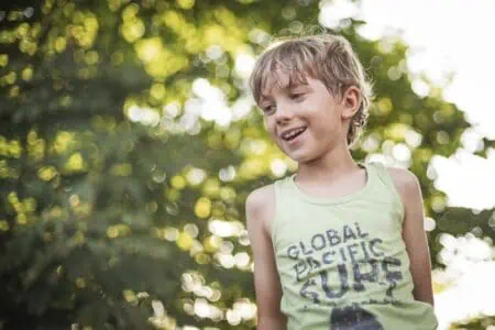 Cheerful young boy having fun outdoors