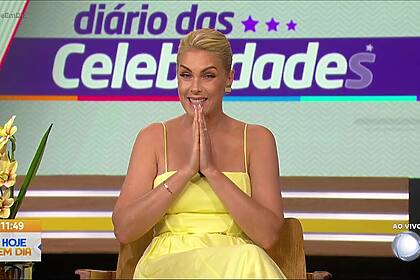 Ana Hickman com vestido de alça amarelo e com a mãos juntas