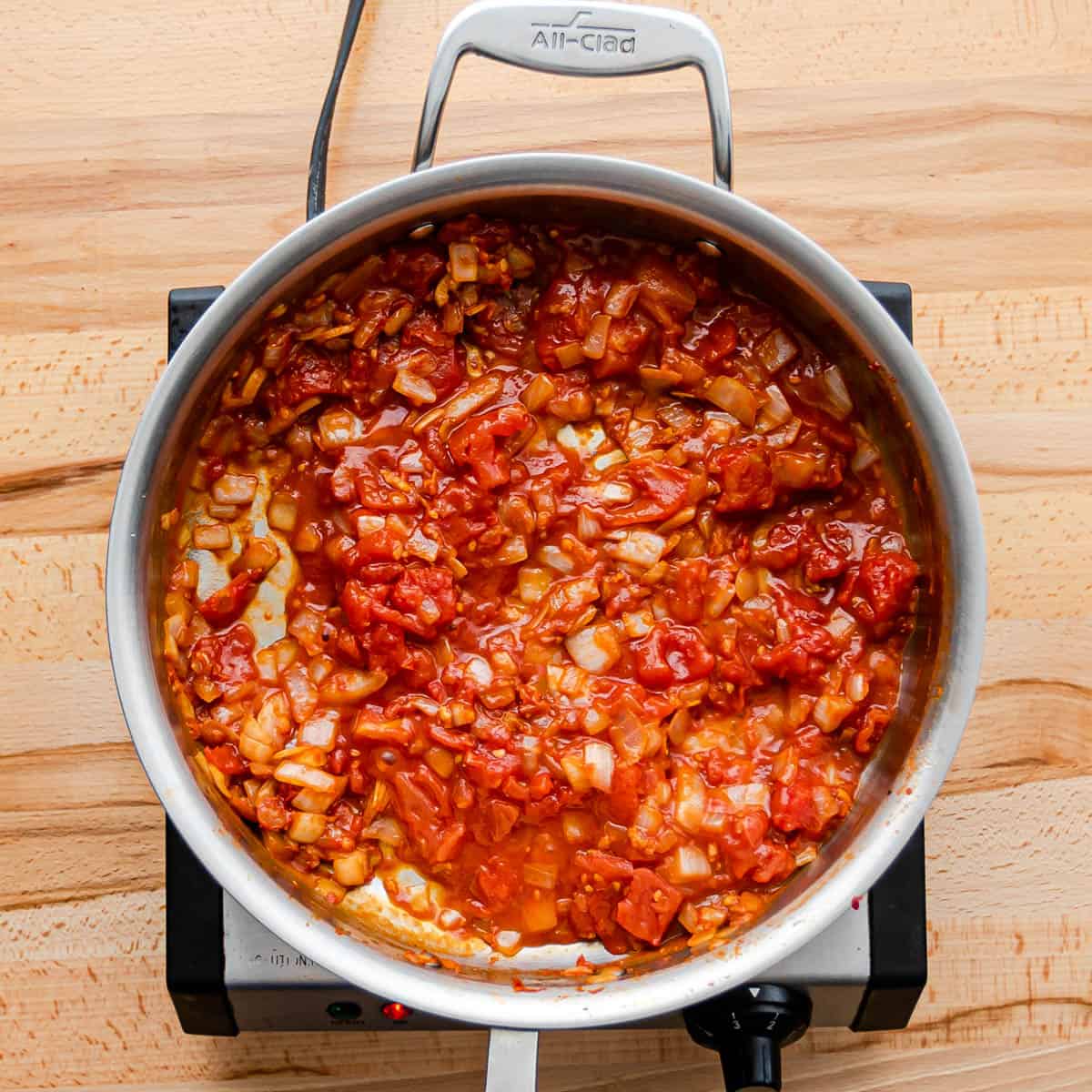 adding tomato product to make sauce for chicken and chorizo pasta.