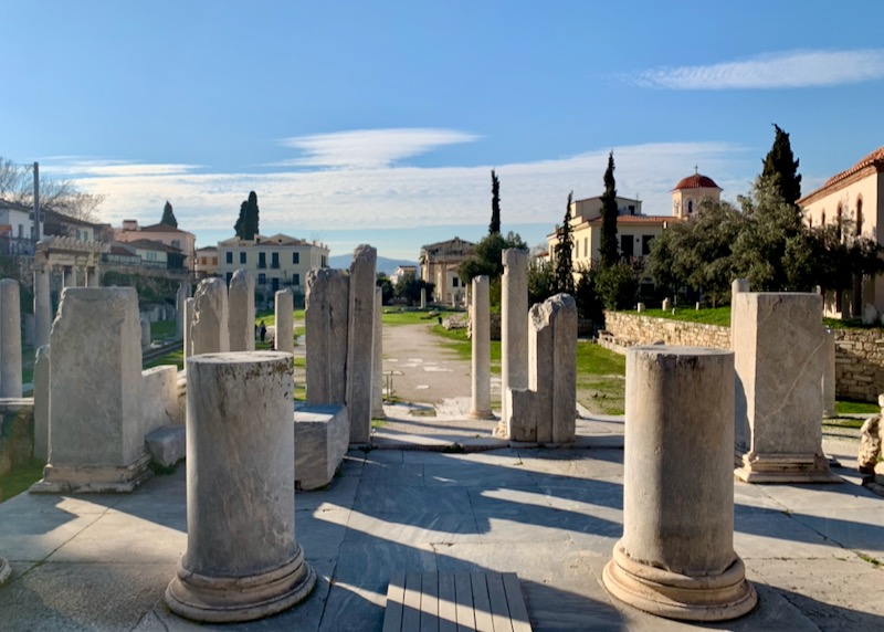 Ancient marble pillars casting long shadows at dusk