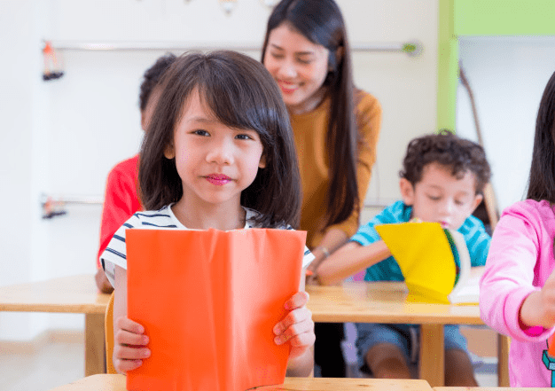 Girl reading book in phonics class