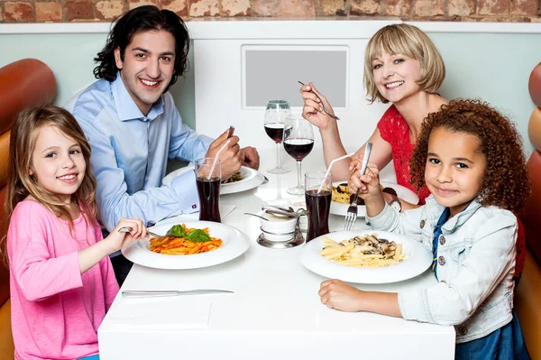 Family eating together in a restaurant — Stock Photo © stockyimages ...