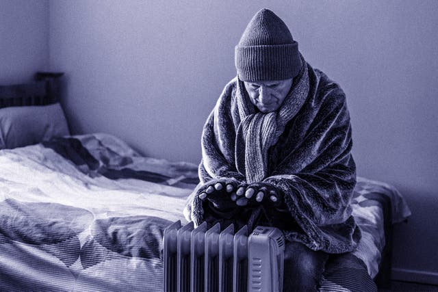 <p>A retired senior man in his 70s sits at home inside his cold house in winter</p>