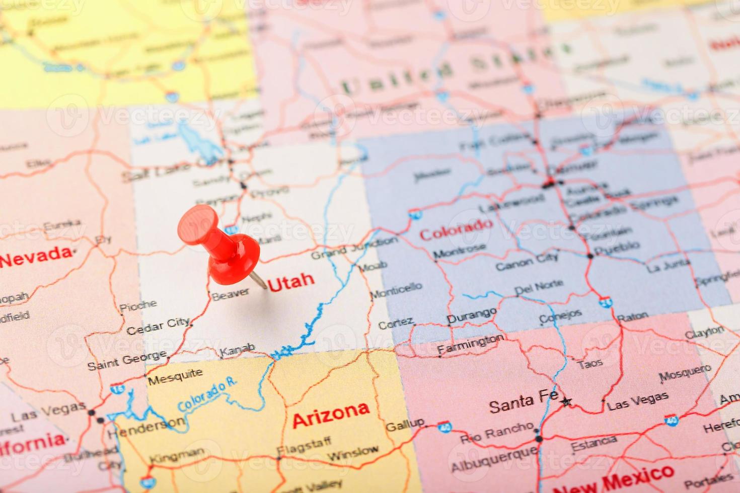 Red clerical needle on a map of USA, Utah and the capital Salt Lake City. Closeup Map Utah with Red Tack photo