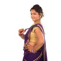 Young Traditional Indian Girl holding kitchen utensil on white background photo