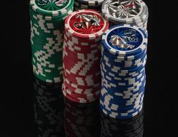 Casino chips on a black background with reflection. The concept of gambling and entertainment. Casino and poker photo