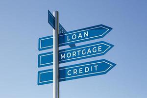 Loan Mortgage Credit words on signpost isolated on sky background photo