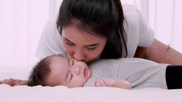 a gentle and loving mother kisses the baby, Slow motion video