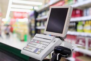 supermarket checkout cash desk counter with payment terminal photo