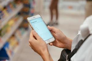 Close up view girl using smartphone in store. photo