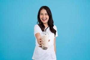 Asian girl holding a cup of pearl milk tea With a smile, fun and happiness photo