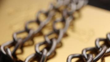 Close up of metal chain links conveying the message of power or entrapment video