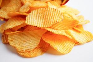 Potato chips in open bag, delicious BBQ seasoning spicy for crips, thin slice deep fried snack fast food. photo