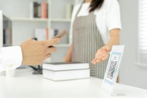 Closeup of a hand hold smartphone and scanning QR code payment. Accepted generate digital pay without money. E wallet and cashless technology.money online, Smart city, Digital transfer, cloud connect. photo