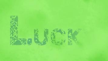 The Word Lucky Decorated in Foliage With Ink Reveal Effect on Green Textured Background video