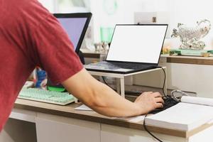 Owner restaurant working on laptop computer at cashier counter. photo