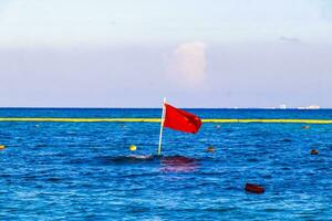 Red flag swimming prohibited high waves Playa del Carmen Mexico. photo