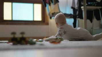 Baby girl crawling on the floor with toys video