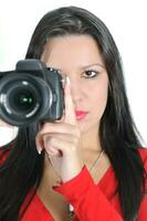 Young woman holding camera in hand taking picture isolated photo