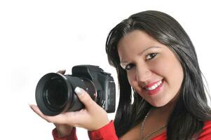 Young woman holding camera in hand taking picture isolated photo