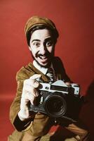 very positive photographer posing in studio with film camera photo