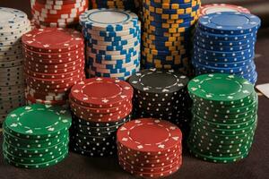 Close-up shot of a poker chips stacks standing on a table in casino. photo