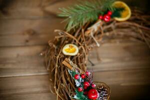 Christmas decoration with pine cones, fir branches, red berries and oranges photo