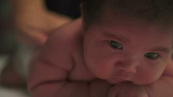 Close Up of a adorable baby sleepy while lying on the bed at home. video