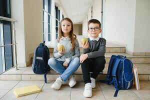 School kids with books together in corridor. Conception of education photo