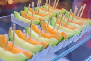 Sliced Japanese Melon for sale in street food market photo