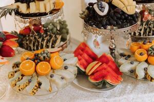 Fruit buffet for a wedding. Assortment of exotic fruits in the restaurant. Various compositions from fresh fruits. photo