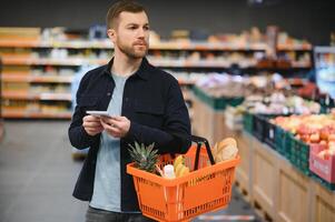 Man shopping in a supermarket photo