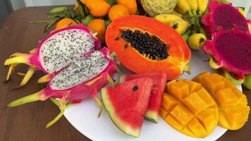 Exotic tropical fruit on table. Thai fruit. Papaya fruit cut in half. close-up video