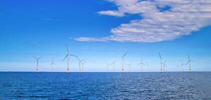 Offshore Wind Turbine in a Windfarm under construction off the England Coast photo