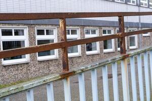 rusty railing in front of old office building photo