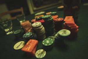 Poker chips are stacked on a green textured table smoke of cigars fills the room photo