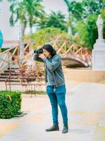 Young photographer taking photos on the street. Male photographer taking photos in a public park, Nagarote