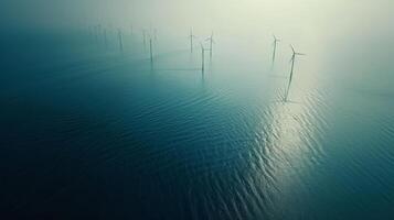 Aerial view of an offshore wind farm with each turbine perfectly aligned in the water photo