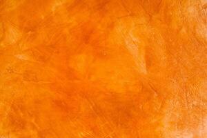 Abstract Orange Oil Paint Texture Background on Brushed Wall photo