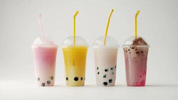 Bubble tea variety in plastic cups with straws on white background. Takeaway drinks concept. photo