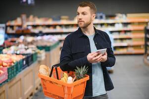 man in supermarket, grocery store customer photo