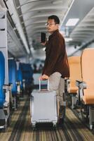 Low Section of Passenger Businessman Walking with Suitcase at the Entrance Walkway in Airport. Focus on Luggage. Low Angle View photo