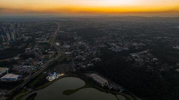 Curitiba in Parana, Brazil. Aerial View. Wonderful sunset with views of buildings and Tangua Park. Lake with reflection. photo