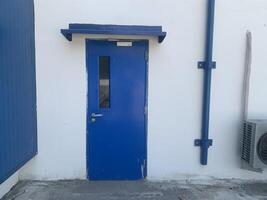 Blue Door on White Wall photo